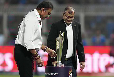 Former India international Ravi Shastri, left, places the winners' trophy in the ground before the start of the T20 World Cup cricket match between India and West Indies in Kolkata.