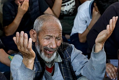 A man mourns as he offers prayers following the alleged killing of Iran's Supreme Leader Ayatollah Ali Khamenei in a US-Israel strike, at a mosque, in Jammu.