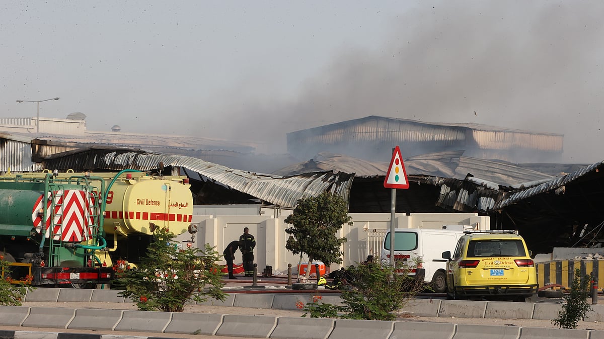 Firefighters work as smoke rises outside a damaged warehouse in an industrial area in Al Rayyan, Qatar, following an Iranian strike, Sunday, March 1, 2026. - | Photo: AP