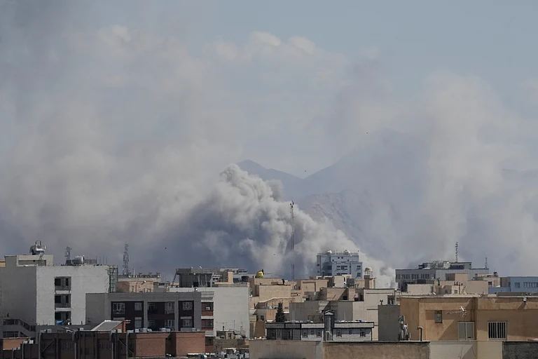 Smoke rises up after a strike in Tehran, Iran, Sunday, March 1, 2026. - AP Photo/Vahid Salemi