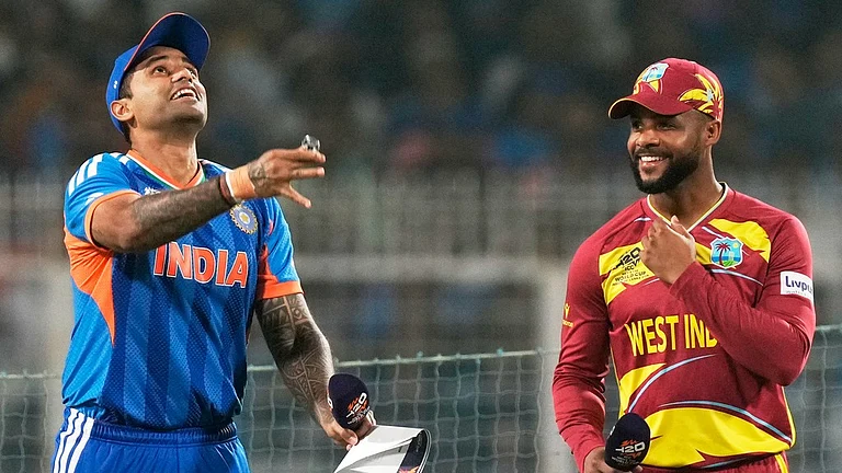 India's captain Suryakumar Yadav, left, tosses the coin as West Indies' captain Shai Hope looks on before the start of the T20 World Cup match between India and West Indies in Kolkata. - Photo: AP