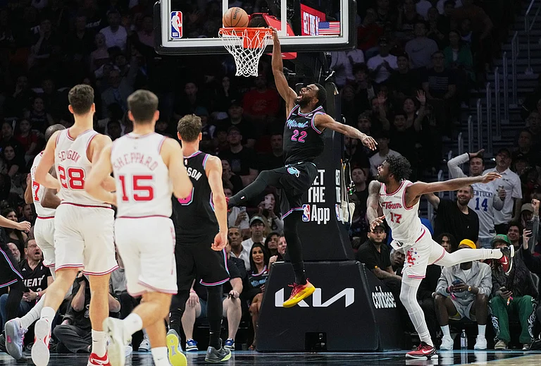Miami Heat forward Andrew Wiggins (22) dunks over Houston Rockets forward Tari Eason (17) during the second half of an NBA basketball game, in Miami. - | Photo: AP/Lynne Sladky