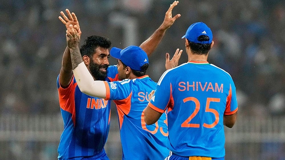 India's Jasprit Bumrah, left, celebrates with captain Suryakumar Yadav the wicket of West Indies' Roston Chase during the T20 World Cup cricket match between India and West Indies in Kolkata. - | Photo: AP/Bikas Das