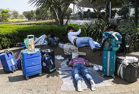 Passengers wait at Chhatrapati Shivaji Maharaj International Airport after flights to Middle East countries were delayed amid the ongoing Iran-Israel conflict, in Mumbai.