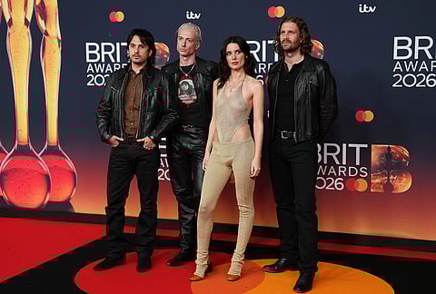 Joel Amey, from left, Theo Ellis, Ellie Rowsell and Joff Oddie of Wolf Alice pose for photographers upon arrival at the Brit Awards 2026 in Manchester, England.