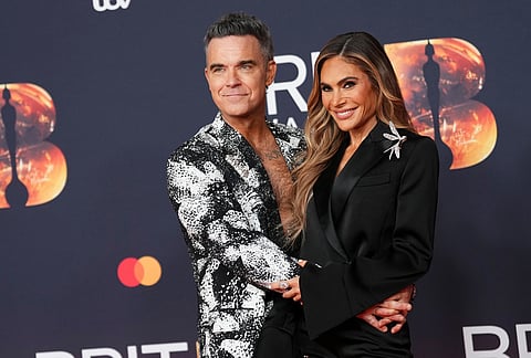 Robbie Williams and Ayda Field Williams pose for photographers upon arrival at the Brit Awards 2026 in Manchester, England.