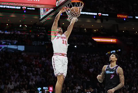 Houston Rockets guard Reed Sheppard (15) dunks over Miami Heat center Kel'el Ware (7) during the second half of an NBA basketball game, in Miami. 