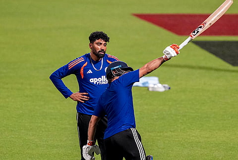 India's Mohammed Siraj, back, and  Ishan Kishan during a practice session ahead of an ICC Men's T20 World Cup 2026 cricket match between India and West Indies, at the Eden Gardens, in Kolkata, West Bengal.