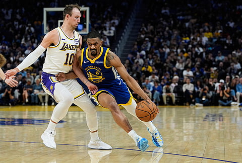 Golden State Warriors guard De'Anthony Melton (8) moves the ball while defended by Los Angeles Lakers guard Luke Kennard (10) during the second half of an NBA basketball game, in San Francisco. 