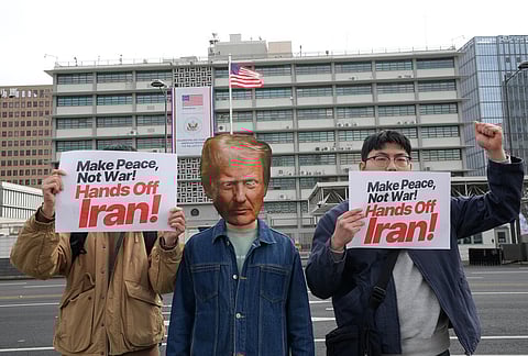 A South Korean protester wearing a mask of U.S. President Donald Trump attends a press conference denouncing the U.S. and Israel's attack on Iran, near the U.S. Embassy in Seoul, South Korea.
