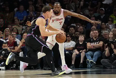 Miami Heat guard Pelle Larsson, left, drives to the basket as Houston Rockets forward Kevin Durant (7) defends during the second half of an NBA basketball game in Miami.