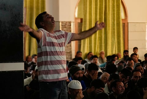 Shiite Muslims mourn the killing of Iranian Supreme Leader Ayatollah Ali Khamenei during a special prayer in Jammu, India.