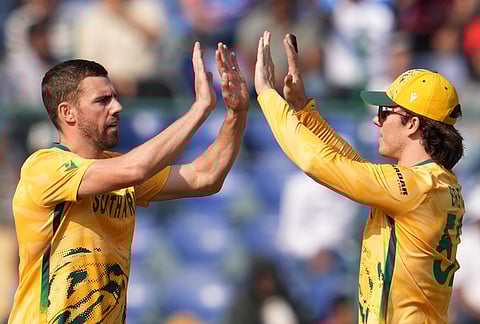 South Africa's Anrich Nortje, left, celebrates the wicket of Zimbabwe's Brian Bennett during the T20 World Cup cricket match between South Africa and Zimbabwe in New Delhi.