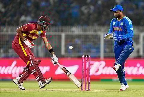 West Indies' Roston Chase makes his crease as India's Sanju Samson looks on during the T20 World Cup cricket match between India and West Indies in Kolkata.
