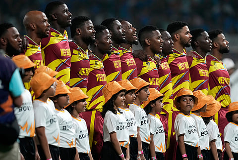 West Indies' players stand up for the national anthems before the start of the T20 World Cup cricket match between India and West Indies in Kolkata.
