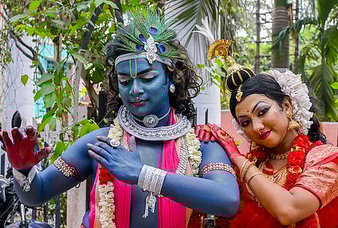 Artists dressed as Lord Krishna and Radha perform during the spring festival celebrations, in Nadia, West Bengal.