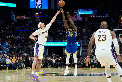 Golden State Warriors forward Draymond Green (23) shoots a 3-point basket next to Los Angeles Lakers center Jaxson Hayes (11) during the second half of an NBA basketball game, in San Francisco. 
