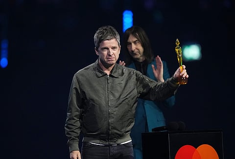 Noel Gallagher, left wins the Songwriter of the year as presented by Bobby Gillespie, during the Brit Awards 2026 in Manchester, England.