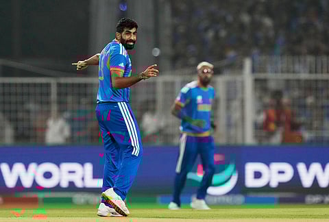India's Jasprit Bumrah, left, reacts in the field during the T20 World Cup cricket match between India and West Indies in Kolkata.
