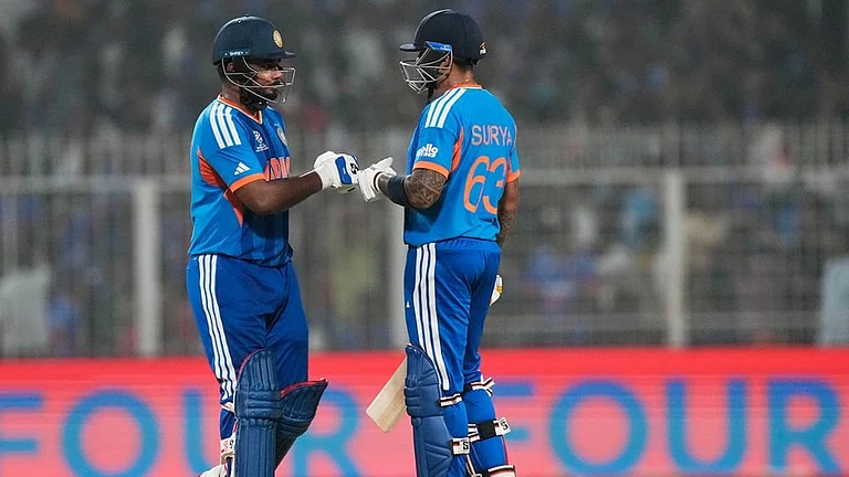 India's captain Suryakumar Yadav, right, and batting partner Sanju Samson touch gloves during the T20 World Cup cricket match between India and West Indies in Kolkata. - | Photo: AP/ Bikas Das
