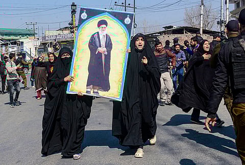 People stage a protest over the killing of Iran's Supreme Leader Ayatollah Ali Khamenei in joint air strikes by the US and Israel, amid severe restrictions on the movement of people in parts of Kashmir, Srinagar.