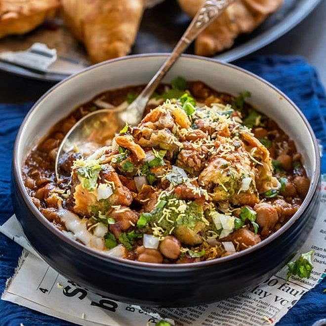 Samosa chaat with chickpeas, yogurt, and sev.