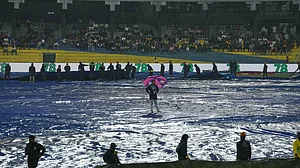 | Photo: AP/Eranga Jayawardena : Groundsmen cover the field as it begins to rain before the start of the T20 World Cup cricket match between New Zealand and Pakistan in Colombo, Sri Lanka, Saturday, Feb. 21, 2026.