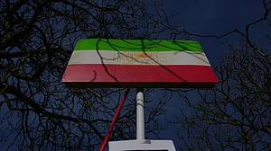 | Photo: AP/Kin Cheung : A historic Iranian national flag is displayed by protesters outside the Iranian Embassy in London, Monday, March 2, 2026.