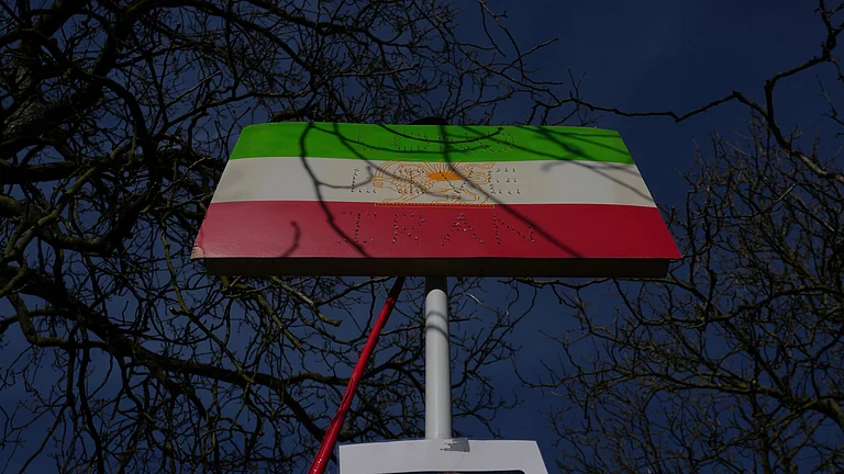 A historic Iranian national flag is displayed by protesters outside the Iranian Embassy in London, Monday, March 2, 2026. - | Photo: AP/Kin Cheung