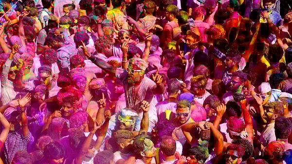 Vibrant Holi crowd dancing in Pushkars main square
