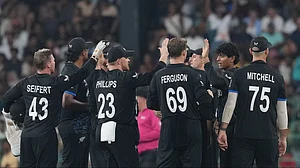 | Photo: AP/Eranga Jayawardena : New Zealand's Rachin Ravindra, second from right, celebrates with teammates the wicket of England's Tom Banton during the T20 World Cup cricket match between England and New Zealand in Colombo, Sri Lanka, Friday, Feb. 27, 2026.