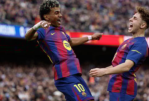 Barcelona's Lamine Yamal, left, celebrates scoring his side's opening goal with teammate Fermin Lopez during the Spanish La Liga soccer match between Barcelona and Villareal in Barcelona, Spain.