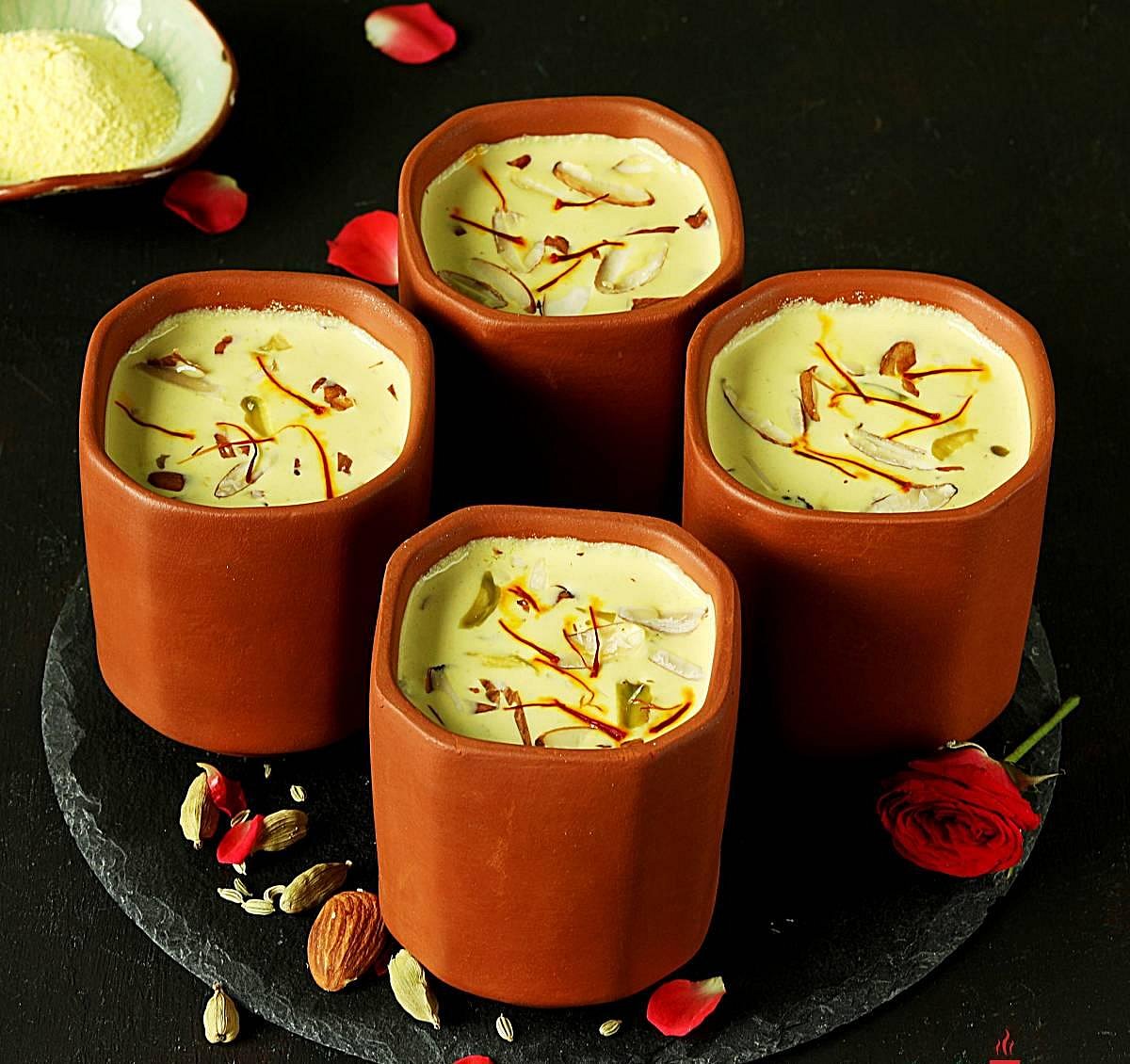 Spiced thandai in four clay cups with saffron