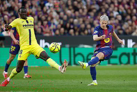 Barcelona's Dani Olmo, right, attempts a shot on goal as Villarreal's Pape Gueye defenses during the Spanish La Liga soccer match between Barcelona and Villareal in Barcelona, Spain.