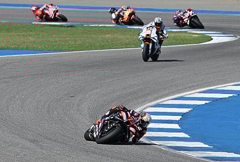 Italy's Marco Bezzecchi of Aprilia Racing is chased by the pack of riders during the MotoGP at the Chang International Circuit in Buriram, Thailand.
