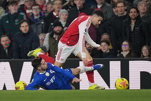 Chelsea's Pedro Neto tackles Arsenal's Gabriel Martinelli during the Premier League soccer match between Chelsea Arsenal in London.