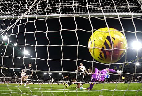 Manchester City's Antoine Semenyo, center, scores against Leeds United during the Premier League soccer match between Leeds United and Manchester City in Leeds, England.