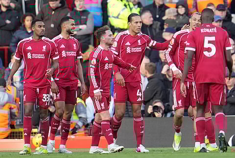 Liverpool players celebrate after a goal during the Premier League soccer match between Liverpool and West Ham United in Liverpool, England.