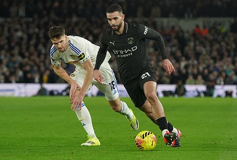 Leeds' Anton Stach, left, and Manchester City's Rayan Ait-Nouri fight for the ballduring the Premier League soccer match between Leeds United and Manchester City in Leeds, England.