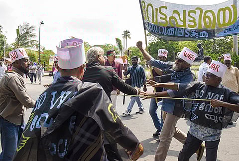 People stage a protest condemning a joint attack by the US and Israel against Iran, in Kochi.