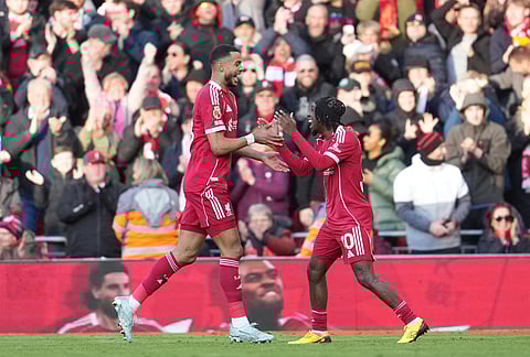 Liverpool's Cody Gakpo, left, and Jeremie Frimpong celebrate after a goal during the Premier League soccer match between Liverpool and West Ham United in Liverpool, England.