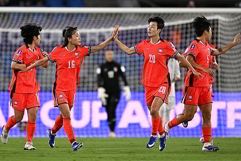 South Korea's Kim Hye-ri, second right, is congratulated by teammate Jang See-gi after scoring a penalty during the Women's Asia Cup soccer match between Iran and South Korea on the Gold Coast, Australia.