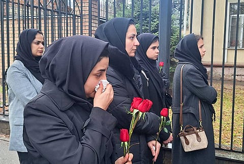 Women gather outside the Embassy of Iran to mourn victims of US-Israeli military strikes, including Supreme Leader Ali Khamenei, several other high-ranking public officials as well as civilian casualties. The latest figures bring to 165 the death toll from the February 28 airstrike on a girls school in Minab, southern Iran.