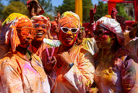 People smeared in 'gulal' during an event organized by Rajasthan Tourism for the 'Holi' festival, in Jaipur, Rajasthan.