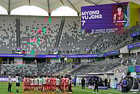 | Photo: AP/Rick Rycroft : North Korean players gather following the Women's Asia Cup soccer match between North Korea and Uzbekistan in Sydney.