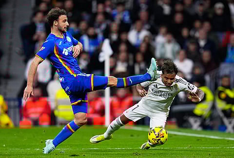 Getafe's Boselli fights for the ball against Real Madrid's Rodrygo during a Spanish La Liga soccer match between Real Madrid and Getafe in Madrid, Spain.