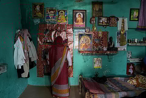 Wall of different gods and leaders at the house of the girl who was murdered and gang-raped.