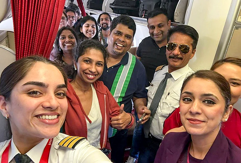 Passengers and crew of Air India flight AI916D from Dubai arrive at the Indira Gandhi International Airport, in New Delhi. The airline said the flight was the first by an Indian carrier to land in the national capital amid the ongoing conflict in the Middle East. - | Photo: @AirIndia_News/X via PTI