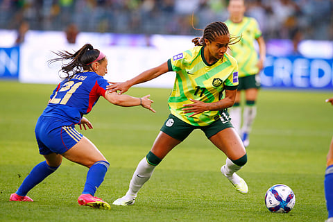 Australia's Mary Fowler, right, battles for the ball with Philippines' Katrina Guillou during the Women's Asia Cup soccer match between Australia and the Philippines in Perth, Australia.