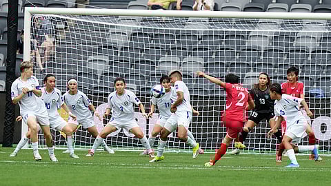 North Korea's Ri Myong gum takes a shot at goal during the Women's Asia Cup soccer match between North Korea and Uzbekistan in Sydney.